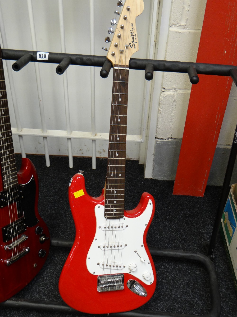 A replica Fender Squire mini electric guitar