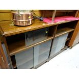 A vintage dark oak double bookcase with sliding glass doors