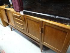 A long G-Plan style sideboard, centre drawers flanked by two cupboards, 202 x 46 x 81cms