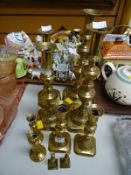 Five pairs of various sized brass candlesticks