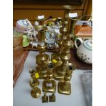 Five pairs of various sized brass candlesticks