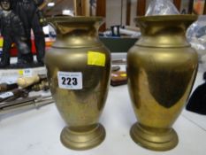 A pair of polished brass Hong Kong made etched decorated vases