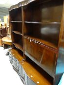 A pair of reproduction mahogany serpentine based display cupboards