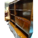 A pair of reproduction mahogany serpentine based display cupboards