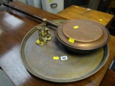 Circular brass tray, copper warming pan, small brass candlesticks