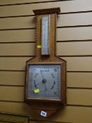 A 1950s light oak barometer made by Phillip Harris & Co, Birmingham