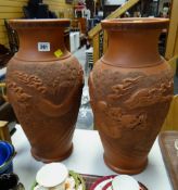 A pair of large Chinese terracotta dragon decorated vases