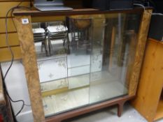 A vintage mirror back glass door display cabinet