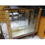 A vintage mirror back glass door display cabinet