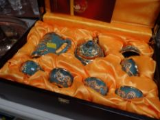 A boxed Chinese ceramic & gilt metal decorated teaset