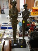 Two cast metal figures on a plinth