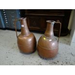 A pair of beaten copper water vessels