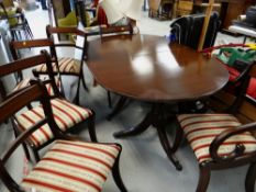 A reproduction mahogany extending dining table with six (4+2) matching chairs