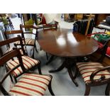 A reproduction mahogany extending dining table with six (4+2) matching chairs