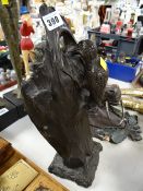 A bronze casting of a woodpecker on a tree entitled 'Homecoming' taken from an original wood carving