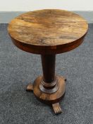 An antique rosewood circular top & tri-footed occasional table