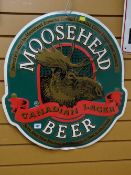 A Moosehead beer metal advertising sign