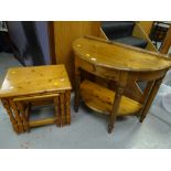 A Ducal honey pine demi-lune hall table with drawer together with a pine nest of three tables