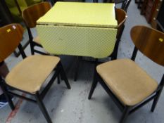 A vintage Formica drop leaf kitchen table together with four matching butterfly backed chairs