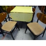 A vintage Formica drop leaf kitchen table together with four matching butterfly backed chairs