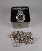 A silver charm bracelet together with an Activator gents wristwatch