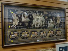 An Oriental framed panel of figures, elephants & dragons, profusely decorated