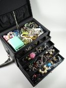A jewellery case containing several drawers of costume jewellery, wristwatches, rings etc
