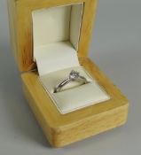 A MODERN PLATINUM & DIAMOND ENGAGEMENT RING set with a brilliant cut diamond, 0.75ct visual