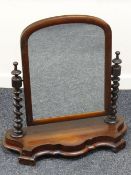VICTORIAN MAHOGANY TOILET-MIRROR with barley-twist supports and shaped base raised with carved feet,