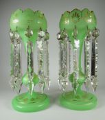 A PAIR OF DROP LUSTRE VASES IN GREEN GLASS with clear lustre-drops suspended from gilded crown-tops,