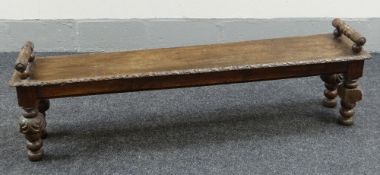 A NINETEENTH CENTURY CARVED BENCH 148cms long