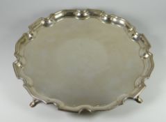 A SILVER GALLERIED-TRAY with inverted stepped border raised on four pad-feet, Birmingham, 1947, by