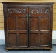 EIGHTEENTH CENTURY OAK CUPBOARD two doors with carved lunette panels to each, carved frieze,