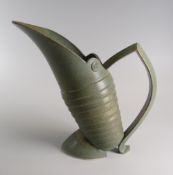 CONTEMPORARY STUDIO POTTERY JUG in rough glaze with coiled body and angular handle, 19cms high