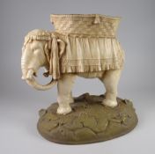 A ROYAL DUX POTTERY DOMESTIC INDIAN ELEPHANT with shortened tusks and howdah on a naturalistic