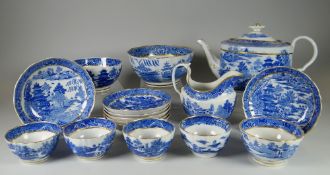AN EARLY NINETEENTH CENTURY BLUE AND WHITE WILLOW PART TEA SET with gilt rim and including teapot,