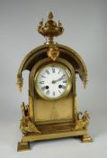 A CLASSICAL STYLE FRENCH BRASS MANTEL CLOCK of architectural form and with gryphon finials, white