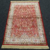 A RED GROUND KASHMIR RUG red ground 'tree-of-life' design, 117 x 170cms