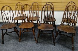 SET OF EIGHT HOOP BACK ELM DINING CHAIRS used with Lot 10, on turned supports and stretchers, the