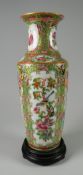 A NINETEENTH CENTURY PORCELAIN FAMILLE-ROSE VASE with tapering and flared neck, decorated with