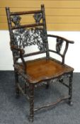 AN ORIENTAL HARDWOOD CHAIR carved all round with bamboo and leaf effect, plain wooden seat