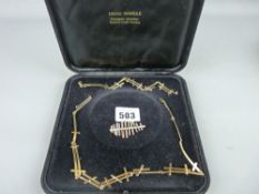 Cased nine carat gold necklace, bracelet and brooch set by David Wardle, 23.8 grms gross