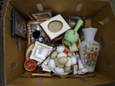 Box containing milk glass vase and an assortment of other ornamental items