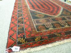 Old Baluchi rug having rich multiple patterns on a predominantly black and red ground, 134 x 87 cms