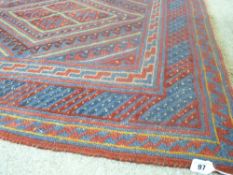 Cazak rug having a central diamond block and banded panel with a multi-bordered edge on a