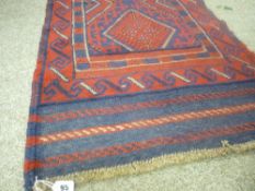 Meshwani carpet runner of red and blue ground, multi-bordered with repeating diamond central