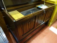 Priory oak style lidded cabinet with linenfold front containing a Sanyo stereo music system with