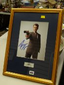 A signed photograph with a certificate of authenticity to the rear of Pierce Brosnan