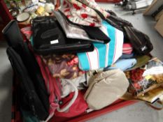 Two crates of ladies' purses, handbags etc