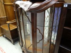 A vintage bow fronted mahogany effect display cabinet